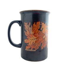 Load image into Gallery viewer, Vintage brown ceramic mug featuring oak leaves and acorns in ochre and honey, with ochreinterior. Design by Stanley Papel. Crafted by Otagiri, Japan, 1970s. A lovely mug to add to your collection.

In excellent condition, no chips or cracks.

Measures 5 x 3 1/2 x 5 inches

Capacity 12 ounces
