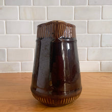 Load image into Gallery viewer, Vintage gloss brown stoneware pitcher with ribbed bands. Crafted by Medalta Stoneware, Canada, 1924. This utilitarian piece nicely complement any farmhouse or cottage kitchen!

In good vintage condition, no chips/cracks/repairs, age-related wear to the exterior. Unmarked.

Measures 5 x 5 1/2 inches
