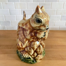 Load image into Gallery viewer, Rare vintage retro figural brown squirrel ceramic cookie jar. Crafted by McCoy Pottery, USA, 1950s. A good sized canister for a large batch of cookies. A great gift for the art pottery collector or animal lover. A whimsical piece that will look wonderful as part of your kitchen decor!

In vintage condition, no chips/cracks/repairs. There is age related crazing with staining at the bottom of the jar. Maker&#39;s mark.

Measures 8 x 6 x 10 1/2 inches
