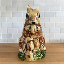 Load image into Gallery viewer, Rare vintage retro figural brown squirrel ceramic cookie jar. Crafted by McCoy Pottery, USA, 1950s. A good sized canister for a large batch of cookies. A great gift for the art pottery collector or animal lover. A whimsical piece that will look wonderful as part of your kitchen decor!

In vintage condition, no chips/cracks/repairs. There is age related crazing with staining at the bottom of the jar. Maker&#39;s mark.

Measures 8 x 6 x 10 1/2 inches
