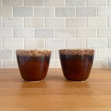 Load image into Gallery viewer, Pair of vintage glossy brown drip glaze mugs. Crafted by Hull Pottery, USA, 1960s. Enjoy any hot beverage in this fabulous retro oven-proof tableware!

In excellent condition, no chips/cracks/repairs. Maker&#39;s marks.

Measures 3 5/8 x 3 1/8 inches

Capacity 8 ounces

