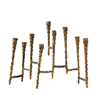 Celebrate the Jewish Festival of Lights with this vintage mid-century era hand forged nine candle bronze Hanukkah / Chanukah menorah. This stunning piece of brutalist Judaica was crafted by American furniture maker, sculptor and designer, Paul Evans circa 1950s. Described by design historian, Dr. Daniella Ohad, as a radical metalsmith, Mr. Evan's work is highly sought after by collectors around the world. In excellent condition with patina. Measures 9 1/8 x 2 1/2 x 8 1/4 inches