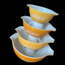 Load image into Gallery viewer, Set of four vintage Butterfly Gold 2 Cinderella nested mixing bowls. including the 441, 442, 443 and 444 sizes This classic was designed by Gregory Mirow and produced by PYREX, USA, 1979-1981. This version of the pattern features an asymmetrical flower and butterfly pattern in white alternating on golden-orange or golden-yellow ground. A must for the vintage kitchen and PYREX enthusiast!

Bowls are in excellent condition, shiny, no chips.
