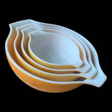 Load image into Gallery viewer, Set of four vintage Butterfly Gold 2 Cinderella nested mixing bowls. including the 441, 442, 443 and 444 sizes This classic was designed by Gregory Mirow and produced by PYREX, USA, 1979-1981. This version of the pattern features an asymmetrical flower and butterfly pattern in white alternating on golden-orange or golden-yellow ground. A must for the vintage kitchen and PYREX enthusiast!

Bowls are in excellent condition, shiny, no chips.
