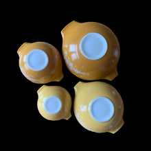 Load image into Gallery viewer, Set of four vintage Butterfly Gold 2 Cinderella nested mixing bowls. including the 441, 442, 443 and 444 sizes This classic was designed by Gregory Mirow and produced by PYREX, USA, 1979-1981. This version of the pattern features an asymmetrical flower and butterfly pattern in white alternating on golden-orange or golden-yellow ground. A must for the vintage kitchen and PYREX enthusiast!

Bowls are in excellent condition, shiny, no chips.
