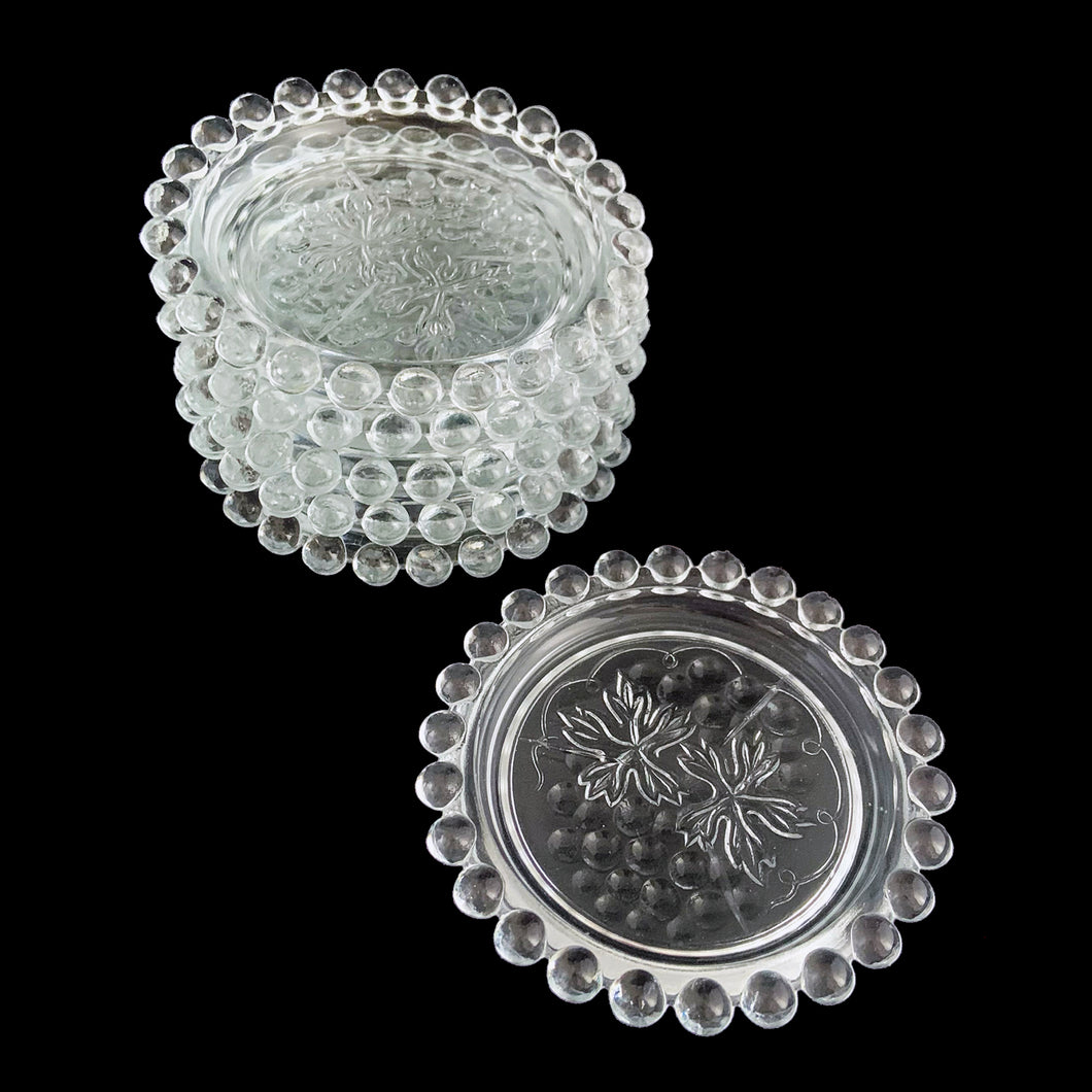 Set of six vintage Candlewick clear glass coasters impressed with grapevines and the distinctive Imperial Candlewick beaded edge. Crafted by Imperial Glass, USA, circa 1960s. The perfect way to protect your furniture and look great doing it! In great vintage condition, free from chips. Two coasters have a bit of roughness on the edge. Measures 4 x 5/8 inches