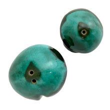 Load image into Gallery viewer, Top-down view of Canuck Pottery Evangeline green drip glaze salt and pepper shaker caps showing shaker holes and mottled teal glaze pattern

