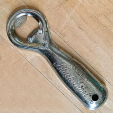 Load image into Gallery viewer, Vintage Carling Black Label classic debossed promotional advertising metal bottle opener with drilled hole for hanging. Crafted by Newell, Canada. A great addition to any beer drinker&#39;s barware collection!

In as found vintage condition.

Measures 5 1/4 inches
