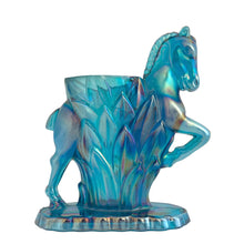 Load image into Gallery viewer, Vintage limited edition Carols Sure Win iridescent Mediterranean Blue Carnival Glass bud vase featuring a horse prancing through vegetation. Made for Cherished Glass Wares by L.E. Smith Glass, USA, 1970s. Production of these vases was limited to approximately 2000 per colour and was produced in Amber, Amberina, Mediterranean Blue and Crystal Lustre.

In excellent condition, no chips. There is a minor rough spot at the seam likely due to mold release.

Measures 4 1/4 x 1 7/8 x 5 1/4 inches
