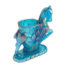 Load image into Gallery viewer, Vintage limited edition Carols Sure Win iridescent Mediterranean Blue Carnival Glass bud vase featuring a horse prancing through vegetation. Made for Cherished Glass Wares by L.E. Smith Glass, USA, 1970s. Production of these vases was limited to approximately 2000 per colour and was produced in Amber, Amberina, Mediterranean Blue and Crystal Lustre.

In excellent condition, no chips. There is a minor rough spot at the seam likely due to mold release.

Measures 4 1/4 x 1 7/8 x 5 1/4 inches
