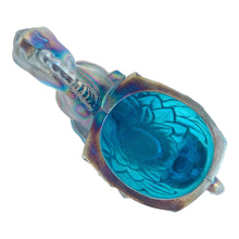 Load image into Gallery viewer, Vintage limited edition Carols Sure Win iridescent Mediterranean Blue Carnival Glass bud vase featuring a horse prancing through vegetation. Made for Cherished Glass Wares by L.E. Smith Glass, USA, 1970s. Production of these vases was limited to approximately 2000 per colour and was produced in Amber, Amberina, Mediterranean Blue and Crystal Lustre.

In excellent condition, no chips. There is a minor rough spot at the seam likely due to mold release.

Measures 4 1/4 x 1 7/8 x 5 1/4 inches
