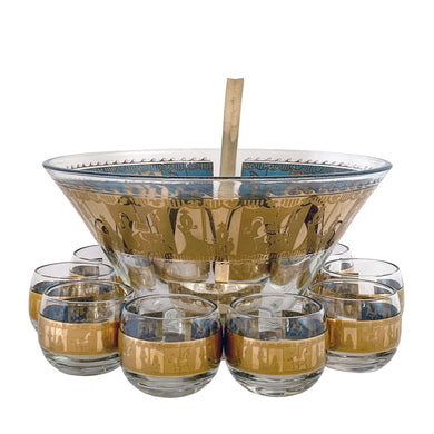 Fabulous vintage mid-century modern Carousel punch bowl with ten matching roly poly glasses and gold toned metal ladle. The glassware is decorated with carousel horses and carriages in 22kt gold on teal blue paint. Crafted by Colony, USA, circa 1960s. Perfect for serving eggnog, alcohol or non-alcohol punch at your next soirée! Stunning doesn't quite describe this fabulous set which is sure to be a standout at your next party!