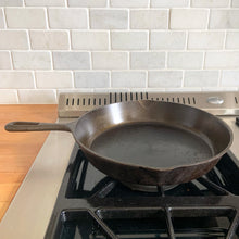 Load image into Gallery viewer, Vintage cast iron 10 1/2 inch frying pan skillet with open handle for easy hanging. Marked Taiwan. We&#39;ve restored this pan and seasoned it with canola oil. Cast iron pans can last a lifetime with proper care and are a great way to add vintage charm to your kitchen decor.

In excellent vintage condition.

Measures 10 7/8 x 15 x 1 3/4 inches (incl. handle)
