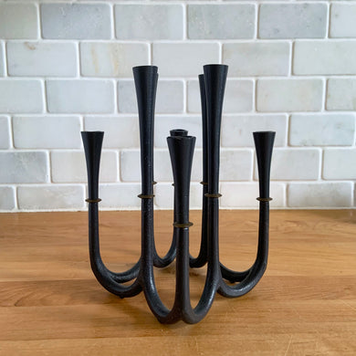 Rare vintage mid-century Danish Modern cast iron and brass candelabra candle holder. Designed by Jens Harald Quistgaard for Dansk, Denmark 1950s. A unique piece of mid-century candle decor that holds 8 slim taper candles!   In excellent condition. Marked 