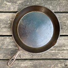 Load image into Gallery viewer, Vintage cast iron 10 1/2 inch frying pan skillet with open handle for easy hanging. Marked Taiwan. We&#39;ve restored this pan and seasoned it with canola oil. Cast iron pans can last a lifetime with proper care and are a great way to add vintage charm to your kitchen decor.

In excellent vintage condition.

Measures 10 7/8 x 15 x 1 3/4 inches (incl. handle)
