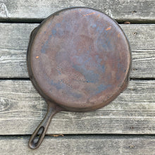 Load image into Gallery viewer, Vintage cast iron 10 1/2 inch frying pan skillet with open handle for easy hanging. Marked Taiwan. We&#39;ve restored this pan and seasoned it with canola oil. Cast iron pans can last a lifetime with proper care and are a great way to add vintage charm to your kitchen decor.

In excellent vintage condition.

Measures 10 7/8 x 15 x 1 3/4 inches (incl. handle)
