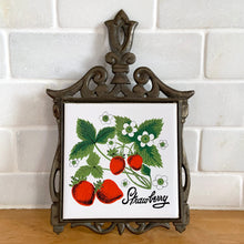 Load image into Gallery viewer, Front view of vintage cast iron trivet with white tile insert featuring strawberries on the vine. Seven Star, Taiwan, 1970s
