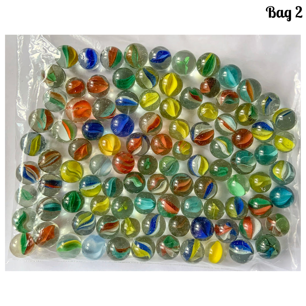 Iconic vintage Cat's Eye machine made marbles in a myriad of colours. One of the children's games of strategy and precision from the 1960s and 1970s. Purchased from the original owner. These take us back to a simpler time! These small colourful glass orbs make a wonderful display in glass jars, fish tanks and vases.  In good condition and cleaned with organic soap and water.  Each bag of marbles contains an assortment of colours in 9/16 inch / 14mm and 5/8 inch / 16mm
