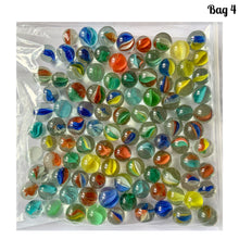 Load image into Gallery viewer, Iconic vintage Cat&#39;s Eye machine made marbles in a myriad of colours. One of the children&#39;s games of strategy and precision from the 1960s and 1970s. Purchased from the original owner. These take us back to a simpler time! These small colourful glass orbs make a wonderful display in glass jars, fish tanks and vases.  In good condition and cleaned with organic soap and water.  Each bag of marbles contains an assortment of colours in 9/16 inch / 14mm and 5/8 inch / 16mm
