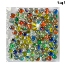 Load image into Gallery viewer, Iconic vintage Cat&#39;s Eye machine made marbles in a myriad of colours. One of the children&#39;s games of strategy and precision from the 1960s and 1970s. Purchased from the original owner. These take us back to a simpler time! These small colourful glass orbs make a wonderful display in glass jars, fish tanks and vases.  In good condition and cleaned with organic soap and water.  Each bag of marbles contains an assortment of colours in 9/16 inch / 14mm and 5/8 inch / 16mm
