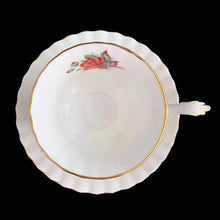 Load image into Gallery viewer, A lovely vintage Centennial Rose Monstrose shaped bone china teacup and saucer. Each piece has a lovely scalloped edge featuring a hand painted rose sprays with gold gilt trim. Crafted by Royal Albert, England, circa 1960s/70s. The perfect vessel for an excellent cuppa tea!

In excellent condition, no chips, cracks or repairs. Maker&#39;s marks on the bottom.

Teacup measures 3 1/2 x 2 3/4 inches | Saucer measures 5 1/2 inches
