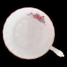 Load image into Gallery viewer, A lovely vintage Centennial Rose Monstrose shaped bone china teacup and saucer. Each piece has a lovely scalloped edge featuring a hand painted rose sprays with gold gilt trim. Crafted by Royal Albert, England, circa 1960s/70s. The perfect vessel for an excellent cuppa tea!

In excellent condition, no chips, cracks or repairs. Maker&#39;s marks on the bottom.

Teacup measures 3 1/2 x 2 3/4 inches | Saucer measures 5 1/2 inches
