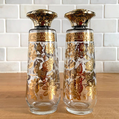 Vintage mid-century modern Chantilly glass salt and pepper shakers decorated in 22 karat gold florals with atomic lids. Crafted by Culver Ltd., USA, 1960s. Hard to find, these will make a fabulous addition to your tableware collection!

In as found vintage condition with age related wear to the gold and lids, no chips. Signed ©Culver Ltd.

Measures 1 7/8 x 5 1/2 inches