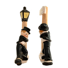 Load image into Gallery viewer, Vintage hand painted drunk Charlie Chaplin hobo hanging off a lamp post and main street sign ceramic salt and pepper shakers. Japan, 1950s. Add these unique shakers to your collection!

In excellent condition, no chips/cracks/repairs. No corks. Marked, Japan.

Measures 2 3/4 x 1 1/8 x 5 inches
