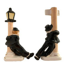 Load image into Gallery viewer, Vintage hand painted drunk Charlie Chaplin hobo hanging off a lamp post and main street sign ceramic salt and pepper shakers. Japan, 1950s. Add these unique shakers to your collection!

In excellent condition, no chips/cracks/repairs. No corks. Marked, Japan.

Measures 2 3/4 x 1 1/8 x 5 inches
