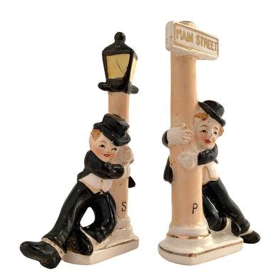 Vintage hand painted drunk Charlie Chaplin hobo hanging off a lamp post and main street sign ceramic salt and pepper shakers. Japan, 1950s. Add these unique shakers to your collection!

In excellent condition, no chips/cracks/repairs. No corks. Marked, Japan.

Measures 2 3/4 x 1 1/8 x 5 inches