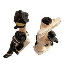 Load image into Gallery viewer, Vintage hand painted drunk Charlie Chaplin hobo hanging off a lamp post and main street sign ceramic salt and pepper shakers. Japan, 1950s. Add these unique shakers to your collection!

In excellent condition, no chips/cracks/repairs. No corks. Marked, Japan.

Measures 2 3/4 x 1 1/8 x 5 inches
