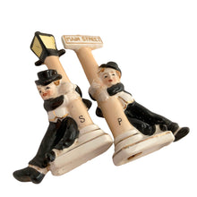 Load image into Gallery viewer, Vintage hand painted drunk Charlie Chaplin hobo hanging off a lamp post and main street sign ceramic salt and pepper shakers. Japan, 1950s. Add these unique shakers to your collection!

In excellent condition, no chips/cracks/repairs. No corks. Marked, Japan.

Measures 2 3/4 x 1 1/8 x 5 inches

