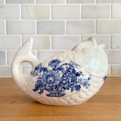 Vintage Charlotte figural fish ironstone creamer featuring blue transferware florals. Crafted by Royal Crownford, England, 1940s. Add a touch of cottage charming to your tableware with this adorable creamer.

In excellent condition, no chips/cracks/repairs. Marked Charlotte Royal Crownford Ironstone England.

Measures 5 1/4 x 3 x 3 3/4 inches