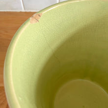 Load image into Gallery viewer, Rare vintage chartreuse green planter pot with embossed flower motif and zig zag borders. Crafted by McCoy Pottery, 1954. This rare planter is must for any McCoy art pottery collector. A wonderful piece to elevate your home and garden decor or to give as a gift!

In as found vintage condition, chip to the rim and crack, no repairs. Normal age-related crazing and manufacturer's glaze pops. Maker's mark on the bottom.

Measures 6 1/2 x 6 1/8 inches
