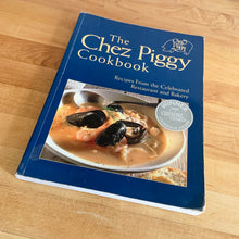 Load image into Gallery viewer, Chez Piggy is a beloved restaurant and bakery in Kingston Ontario Canada. This softcover cookbook contains 239 pages filled with wonderful recipes along with many colour photographs. Published by Firefly Books. Canada, 1988. This is the forth edition 2006.   In great vintage condition with normal age-related yellowing.   
