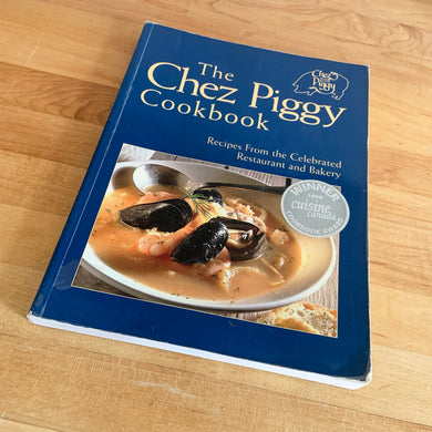 Chez Piggy is a beloved restaurant and bakery in Kingston Ontario Canada. This softcover cookbook contains 239 pages filled with wonderful recipes along with many colour photographs. Published by Firefly Books. Canada, 1988. This is the forth edition 2006.   In great vintage condition with normal age-related yellowing.   