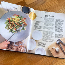 Load image into Gallery viewer, Better Homes and Gardens is known for its fabulous cookbooks. This hardcover cookbook focuses on cooking Chinese inspired recipes. Its 96 pages are filled with amazing recipes along with many colour photographs. Originally published by Meredith Corporation, USA, 1983. First edition, eleventh printing 1988.   In great vintage condition with normal age-related yellowing.
