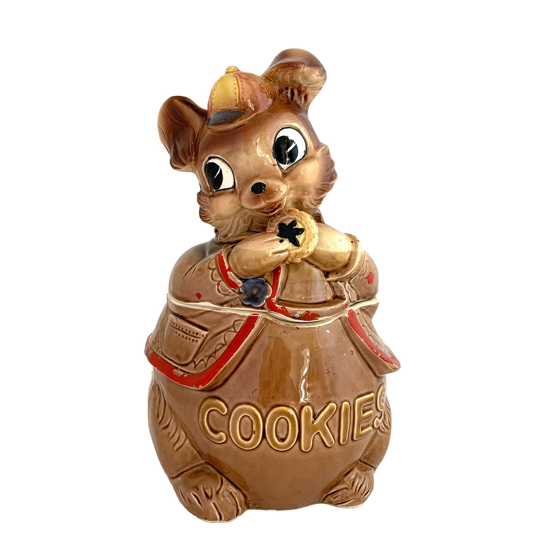 Adorable vintage, mid-century era anthropomorphic chipmunk ceramic cookie jar. Crafted by Royal Sealy, Japan, 1950s. A delightful addition to your cookie jar collection and kitchen decor!

In great vintage condition with wear to the cold paint, no chips, normal crazing commensurate with age. A crazing line extends to the unglazed portion of the lid and there is an X crazing mark on the bottom, neither goes through to the other side.

Measures 6 1/4 x 6 3/4 x 12 1/2 inches