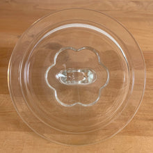 Load image into Gallery viewer, Vintage mid-century chocolate brown glass cookie jar with embossed gingerbread men, donuts, stars and cookies with clear ring handled lid. Crafted by Hazel-Atlas Glass, USA, 1950s. Use this nice sized jar to store cookies or dry goods and add whimsy to your kitchen decor.

In vintage condition with chips to the interior rim of the jar. The lid is in excellent condition, no chips.

Measures 6 1/2 x 10 inches
