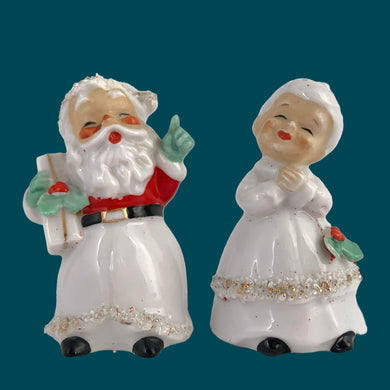 Vintage mid-century beautifully hand painted ceramic Santa and Mrs. Claus salt and pepper shakers. These Christmas themed shakers have the sweetest facial expressions, are nicely painted in red, green and black with gold spaghetti details. Crafted by Lefton, Japan, 1950s. These highly collectible kitschy shakers are the perfect accent for your Christmas holiday decor!