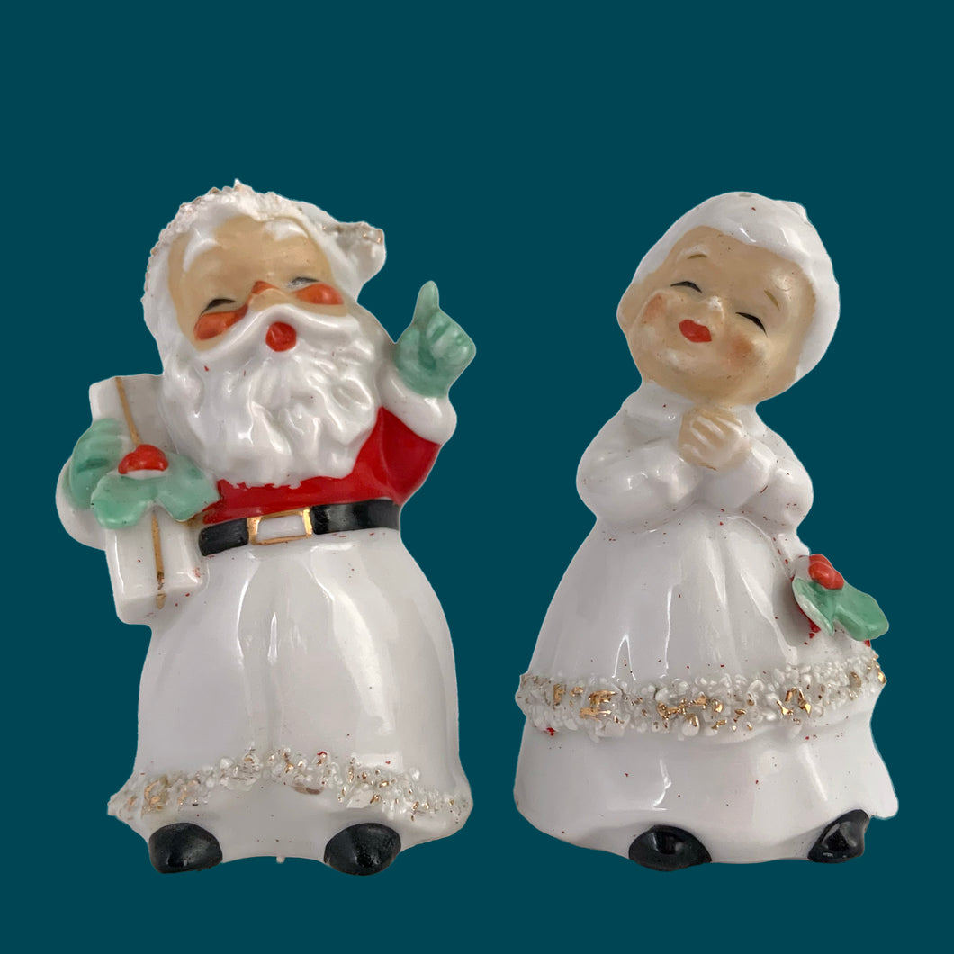 Vintage mid-century beautifully hand painted ceramic Santa and Mrs. Claus salt and pepper shakers. These Christmas themed shakers have the sweetest facial expressions, are nicely painted in red, green and black with gold spaghetti details. Crafted by Lefton, Japan, 1950s. These highly collectible kitschy shakers are the perfect accent for your Christmas holiday decor!