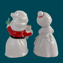 Load image into Gallery viewer, Vintage mid-century beautifully hand painted ceramic Santa and Mrs. Claus salt and pepper shakers. These Christmas themed shakers have the sweetest facial expressions, are nicely painted in red, green and black with gold spaghetti details. Crafted by Lefton, Japan, 1950s. These highly collectible kitschy shakers are the perfect accent for your Christmas holiday decor!
