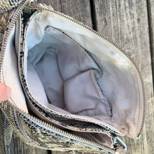 Load image into Gallery viewer, Pre-owned Ciana taupe faux python cross-body bag with adjustable strap is crafted from durable textured cow leather and features polished silver tone hardware. By Danier Leather. The zippered polyester lined interior has three compartments, one zippered pocket and metal keychain holder, one with snap closure, and one with 2-part open pocket. Exterior 2 zippered and snap closure pockets. A stylish, durable and practical accessory.
