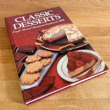 Load image into Gallery viewer, Borden is known for its fabulous dairy products. This hardcover cookbook focuses on recipes using Eagle Brand Sweetened Condensed Milk. Its 216 pages are filled with amazing  recipes along with many colour photographs. Published for Borden Inc., by Publications International USA, 1989.   In great vintage condition with normal age-related yellowing.   
