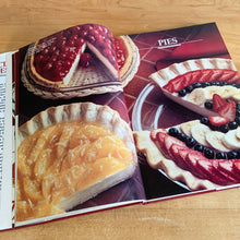 Load image into Gallery viewer, Borden is known for its fabulous dairy products. This hardcover cookbook focuses on recipes using Eagle Brand Sweetened Condensed Milk. Its 216 pages are filled with amazing  recipes along with many colour photographs. Published for Borden Inc., by Publications International USA, 1989.   In great vintage condition with normal age-related yellowing.   
