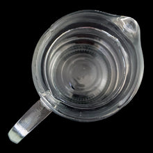 Load image into Gallery viewer, Overhead view of vintage clear ribbed beehive glass pitcher showing spout opening and rib pattern
