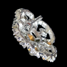 Load image into Gallery viewer, Side profile of vintage rhinestone brooch showing depth of openwork silver-tone frame and pin clasp mechanism
