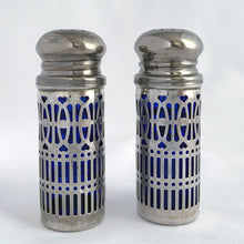 Load image into Gallery viewer, Vintage cobalt blue glass salt and pepper shakers featuring silver plate filigree sleeves. UK Patent 1014132, England. We&#39;ve polished these and they will look lovely on any tablescape!  In good vintage condition, no chips to the glass. Wear to the lids, see photos.&nbsp;  Measures 7/8 x 2 3/4 inches
