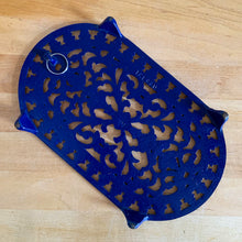Load image into Gallery viewer, Jacks Daughter of All Trades Vintage Antique Mid-Century Kitsch Store Shop Reseller Etsy Shopify Toronto Canada Free Porch Pick Up Local Delivery Worldwide Shipping Judy Weinberg Unique Housewarming Gift Sustainable Gift Wedding Gift Home Decor Collectible Collector Gift Farmhouse Cottagecore Cottage Lodge Shabby Chic cobalt blue oval cast iron trivet floral filigree design Taiwan 1970s wall decor kitchen decor
