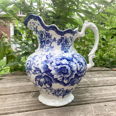 Excited to bring this stunning antique Victorian era white ironstone cobat blue transferware poppy flower patterned pitcher. Produced by Colonial Pottery in Stoke-on-Trent, England, between 1890-1925 based on the makers mark.  In good vintage condition, free from chips/cracks. Normal crazing present. There is a small flea bite on the top of the handle and a small area of discolouration.  Measures approximately  12 inches tall